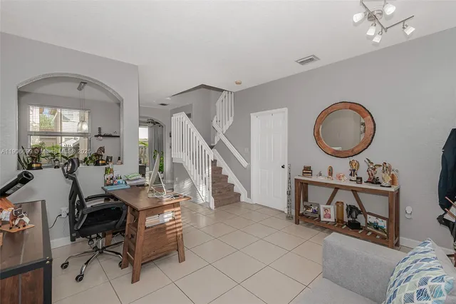a view of a livingroom with furniture and a mirror