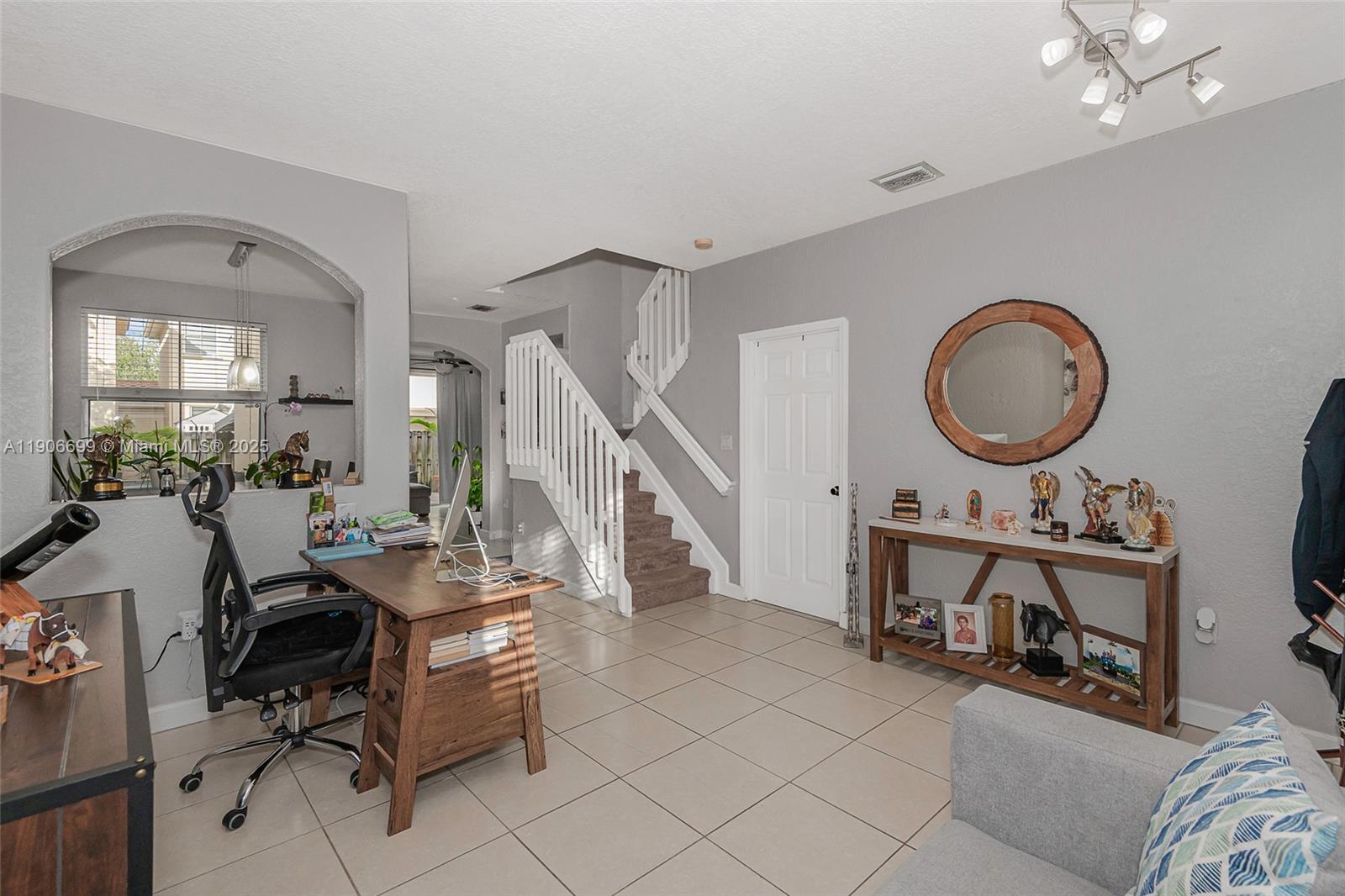3816 Southwest 169th Terrace Miramar, FL 33027 - Photo 3 of 21 a view of a livingroom with furniture and a mirror