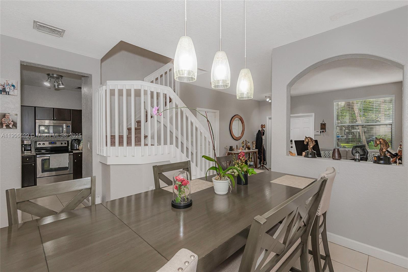 3816 Southwest 169th Terrace Miramar, FL 33027 - Photo 5 of 21 a view of a dining room and kitchen with furniture and large windows