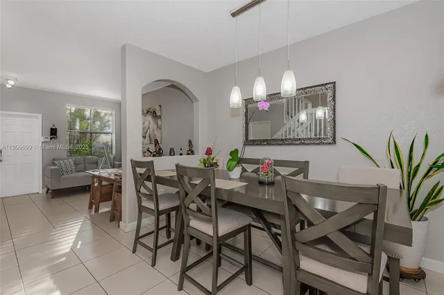 a view of a dining room with furniture and a chandelier