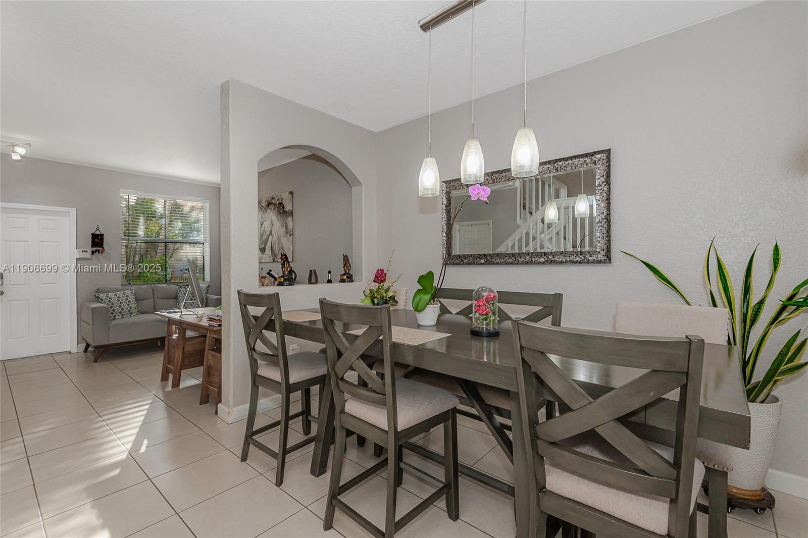 3816 Southwest 169th Terrace Miramar, FL 33027 - Photo 6 of 21 a view of a dining room with furniture and a chandelier