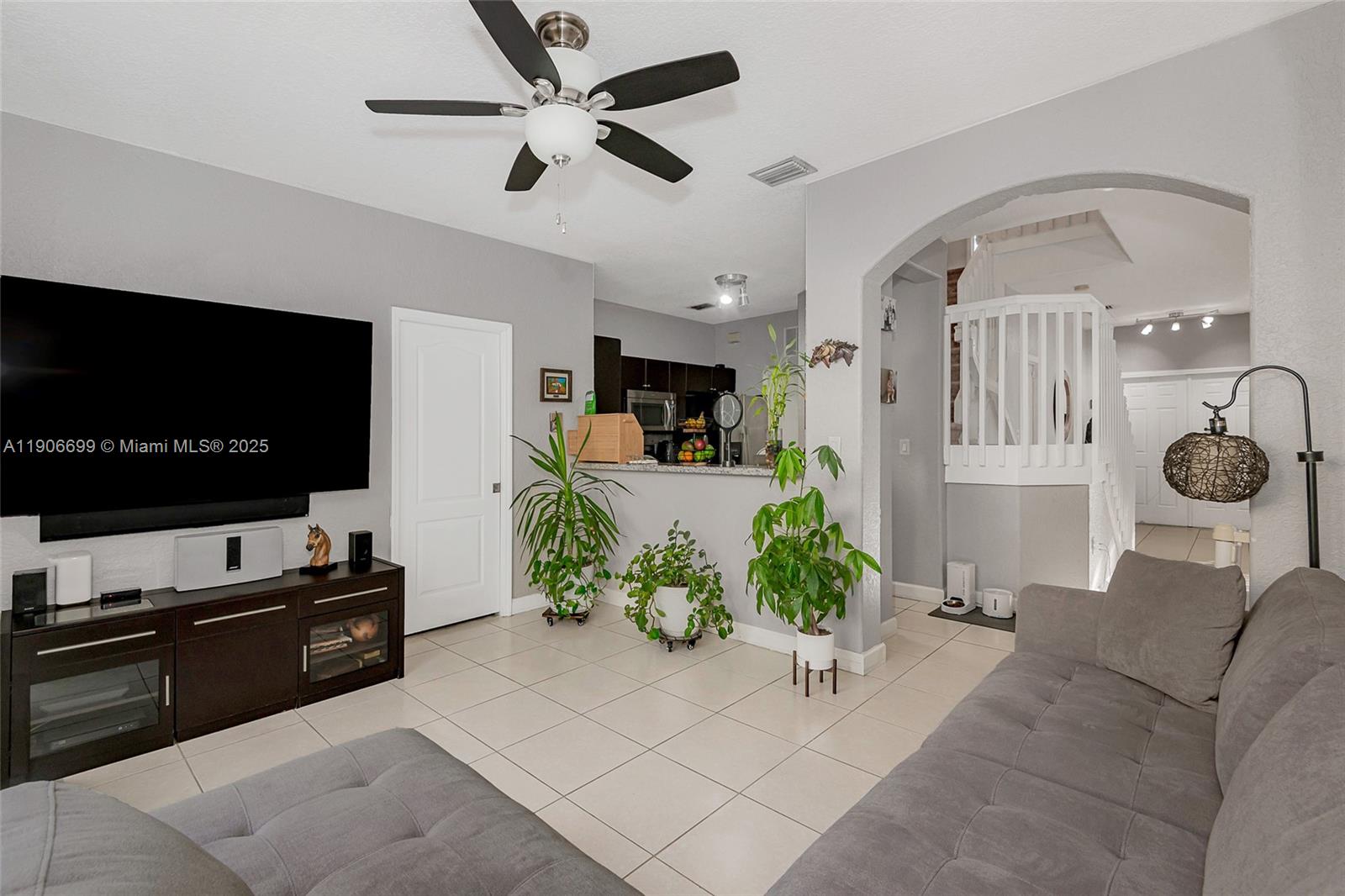3816 Southwest 169th Terrace Miramar, FL 33027 - Photo 10 of 21 a living room with furniture and a flat screen tv