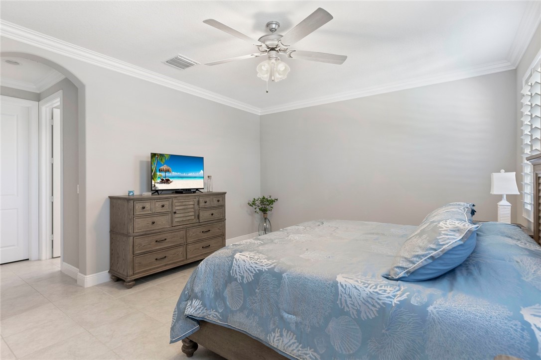 7203 33rd Square Vero Beach, FL 32967 - Photo 11 of 28 a bedroom with a bed and a dresser