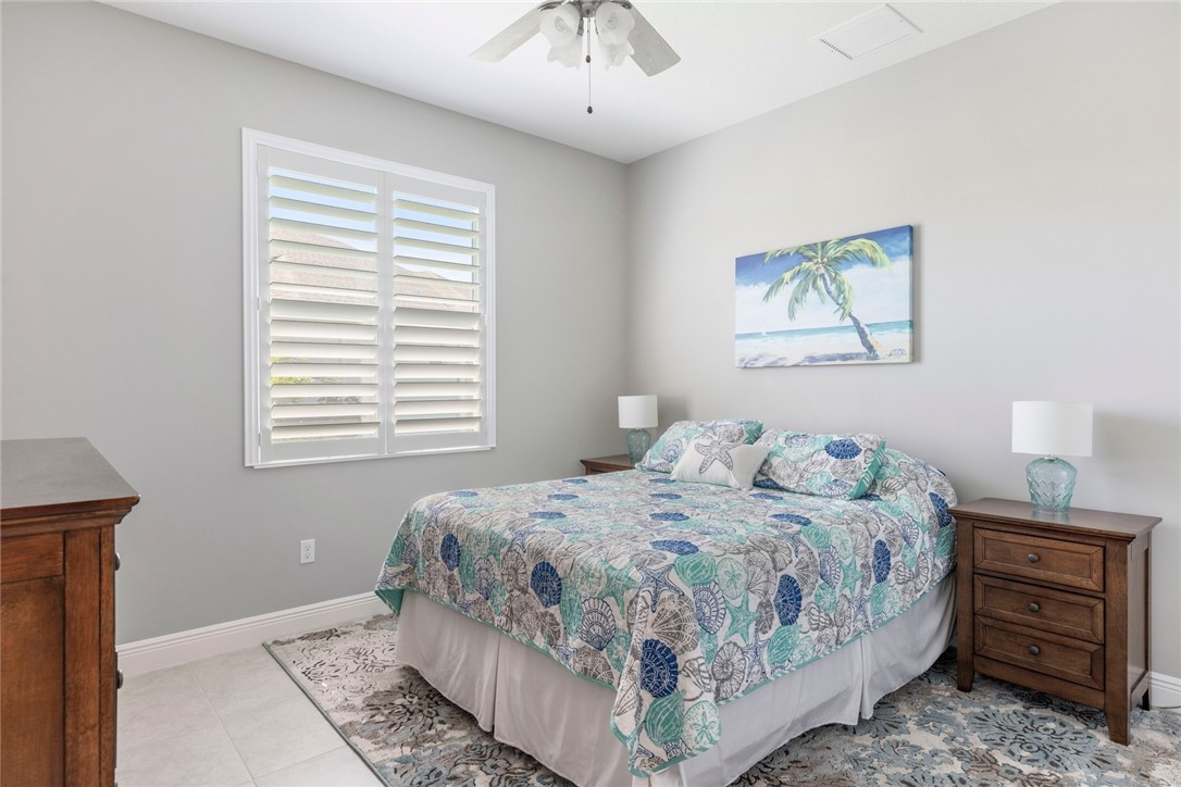 7203 33rd Square Vero Beach, FL 32967 - Photo 15 of 28 a bedroom with a bed and a window