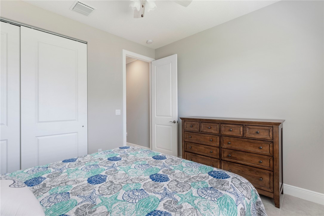 7203 33rd Square Vero Beach, FL 32967 - Photo 16 of 28 a bedroom with a bed and a dresser