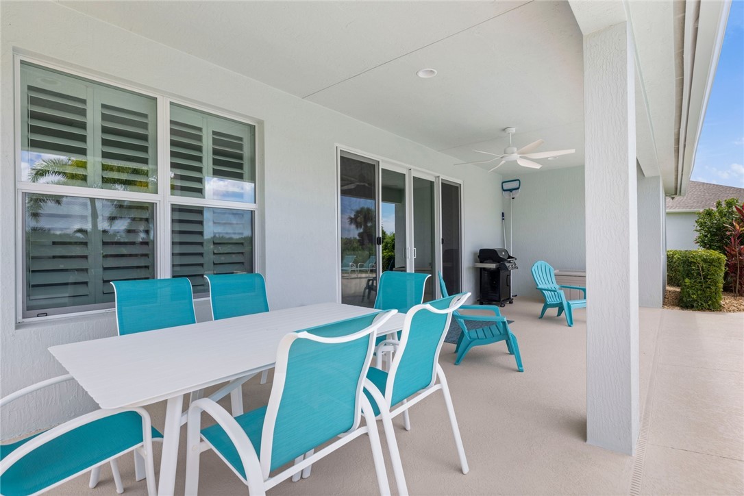 7203 33rd Square Vero Beach, FL 32967 - Photo 18 of 28 a view of a dining room with furniture window and wooden floor