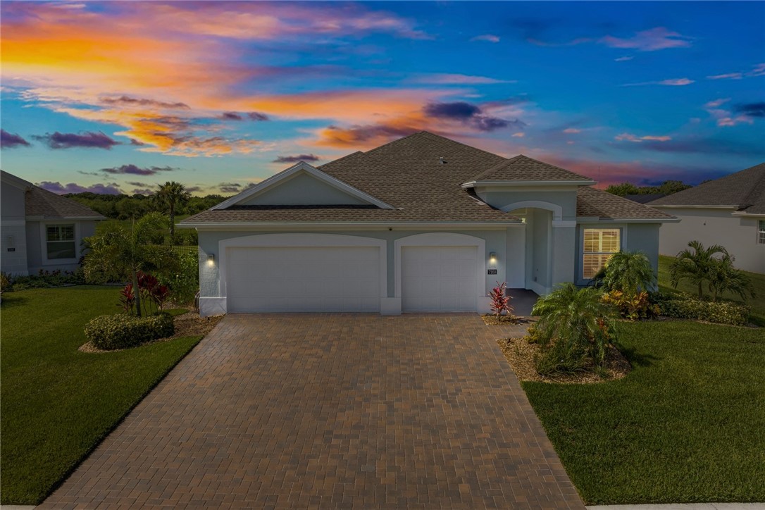 7203 33rd Square Vero Beach, FL 32967 - Photo 28 of 28 a front view of a house with a yard and garage