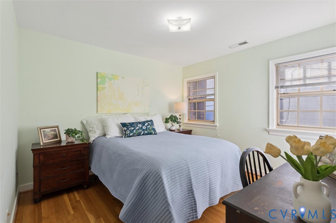 421 Scotland Street, Unit 3 Williamsburg, VA 23185 - Photo 16 of 26 a bedroom with a bed and wooden floor