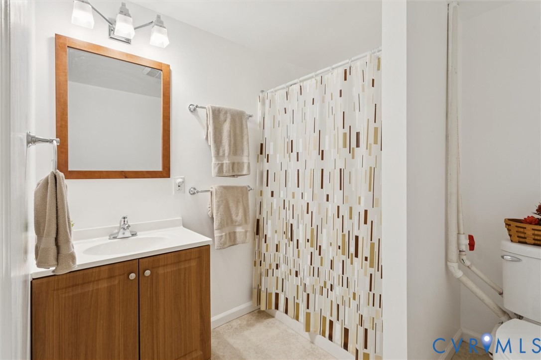 421 Scotland Street, Unit 3 Williamsburg, VA 23185 - Photo 21 of 26 a bathroom with a sink vanity and a mirror