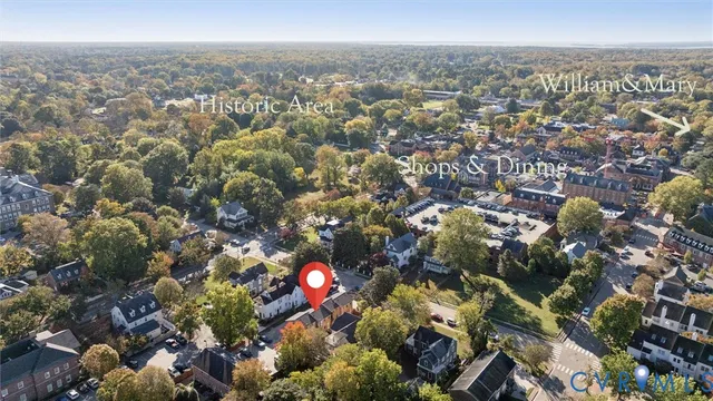 a view of a hallway with wooden floor and a bathroom