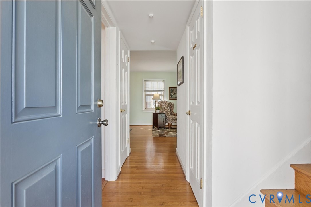 421 Scotland Street, Unit 3 Williamsburg, VA 23185 - Photo 4 of 26 a view of a hallway with wooden floor and a bathroom