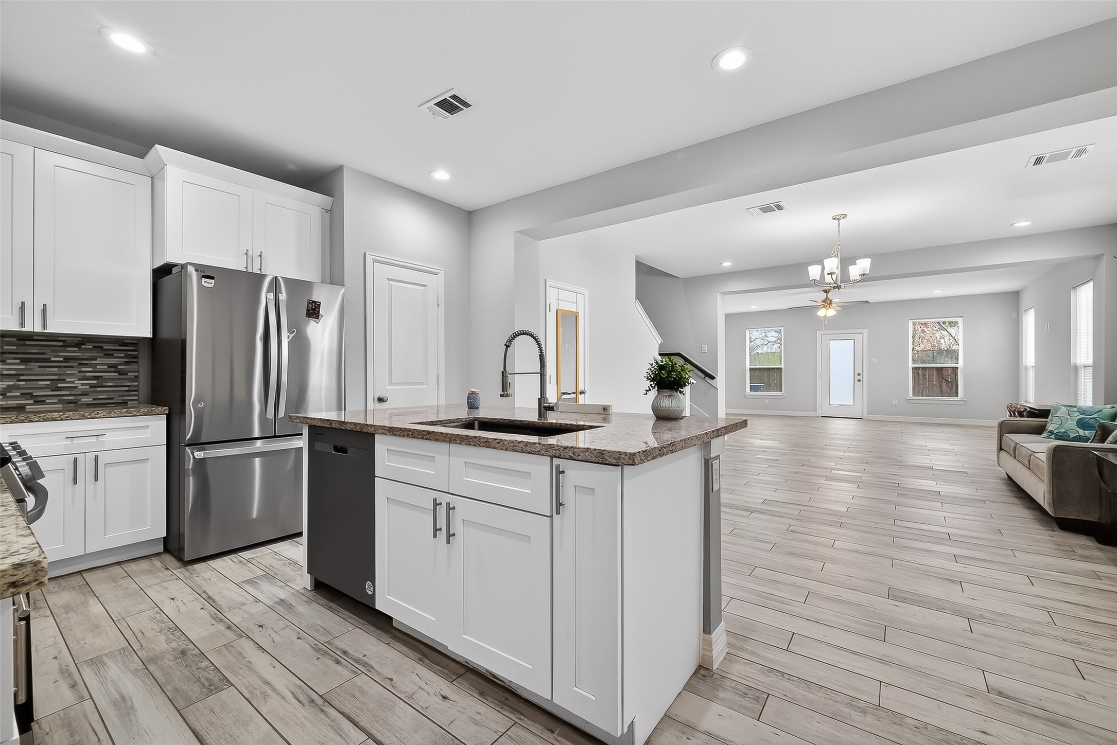 1411 Featherstone Street, Unit B Houston, TX 77020 - Photo 12 of 32 a kitchen with sink cabinets and stainless steel appliances