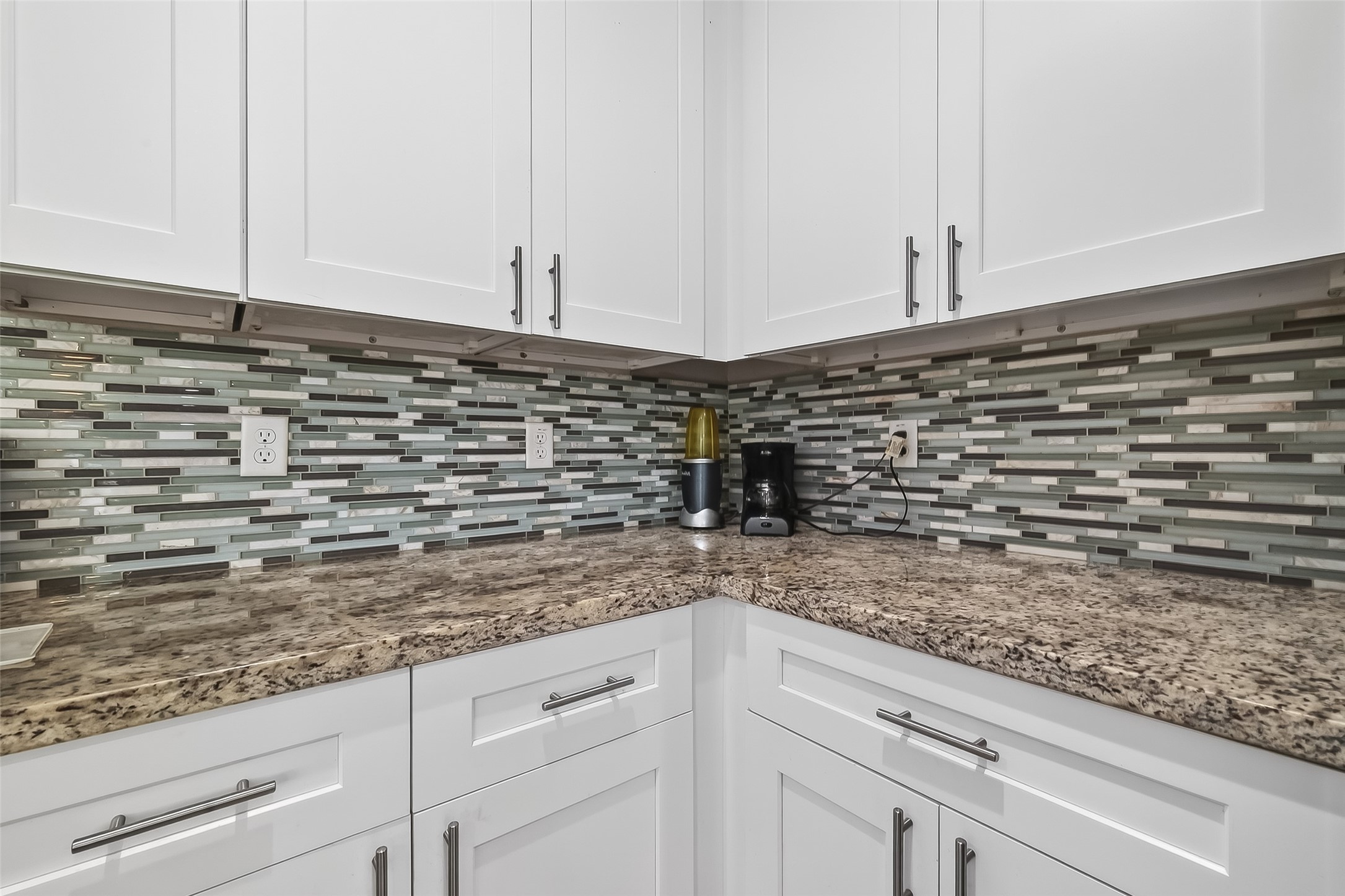1411 Featherstone Street, Unit B Houston, TX 77020 - Photo 14 of 32 a kitchen with granite countertop white cabinets and a wooden floor