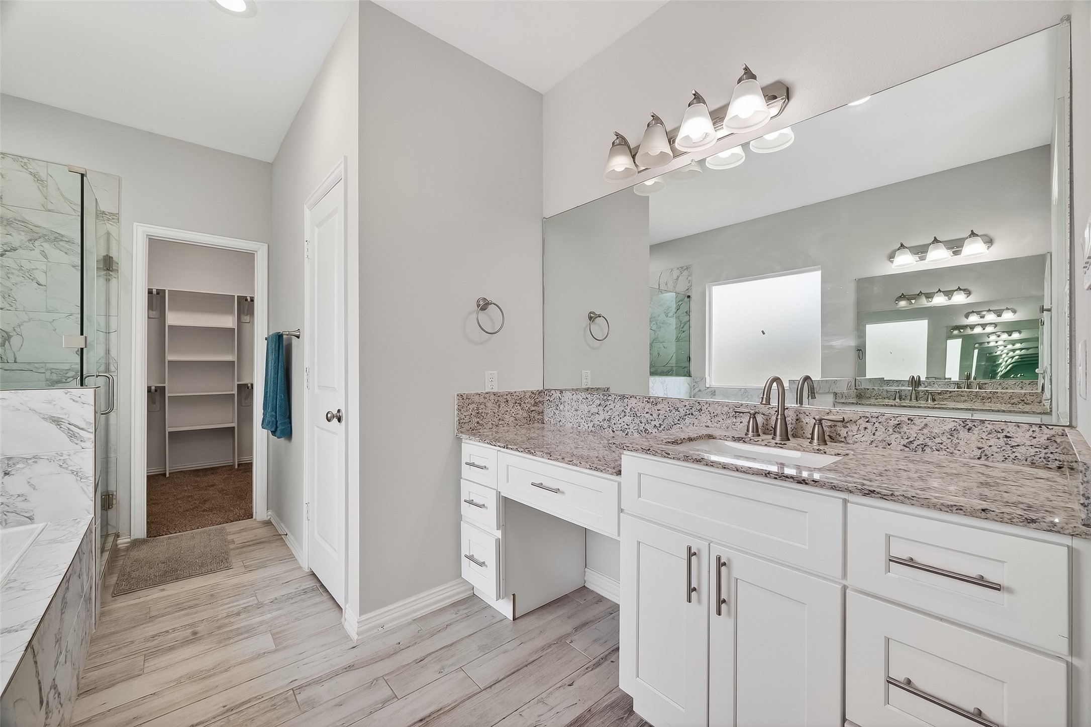 1411 Featherstone Street, Unit B Houston, TX 77020 - Photo 21 of 32 a bathroom with a granite countertop sink a mirror and a shower