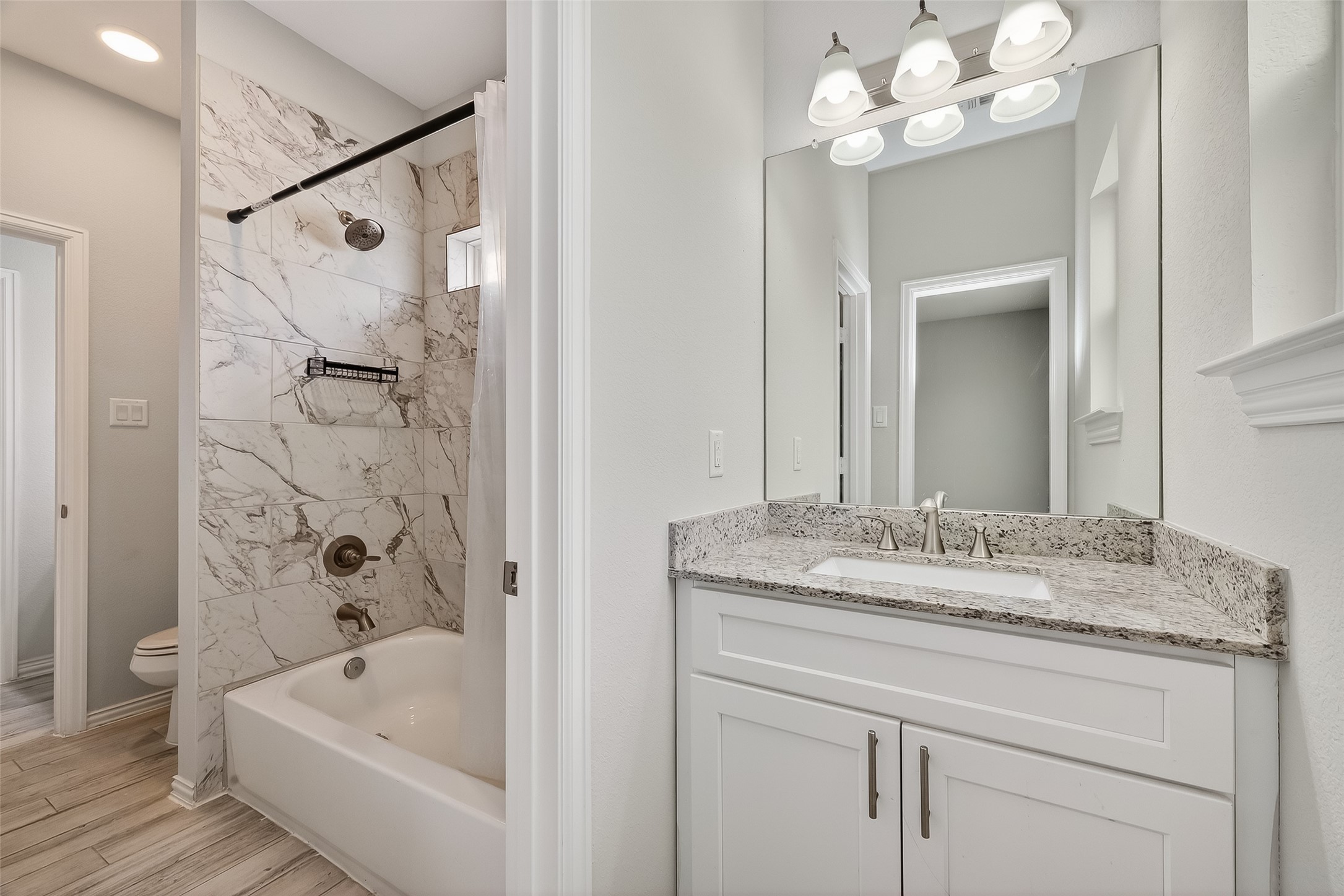 1411 Featherstone Street, Unit B Houston, TX 77020 - Photo 28 of 32 a bathroom with a tub sink and mirror