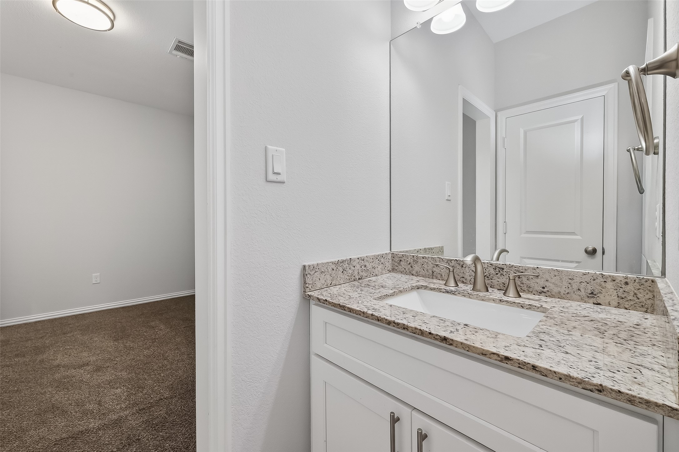 1411 Featherstone Street, Unit B Houston, TX 77020 - Photo 29 of 32 a bathroom with a granite countertop sink and a mirror