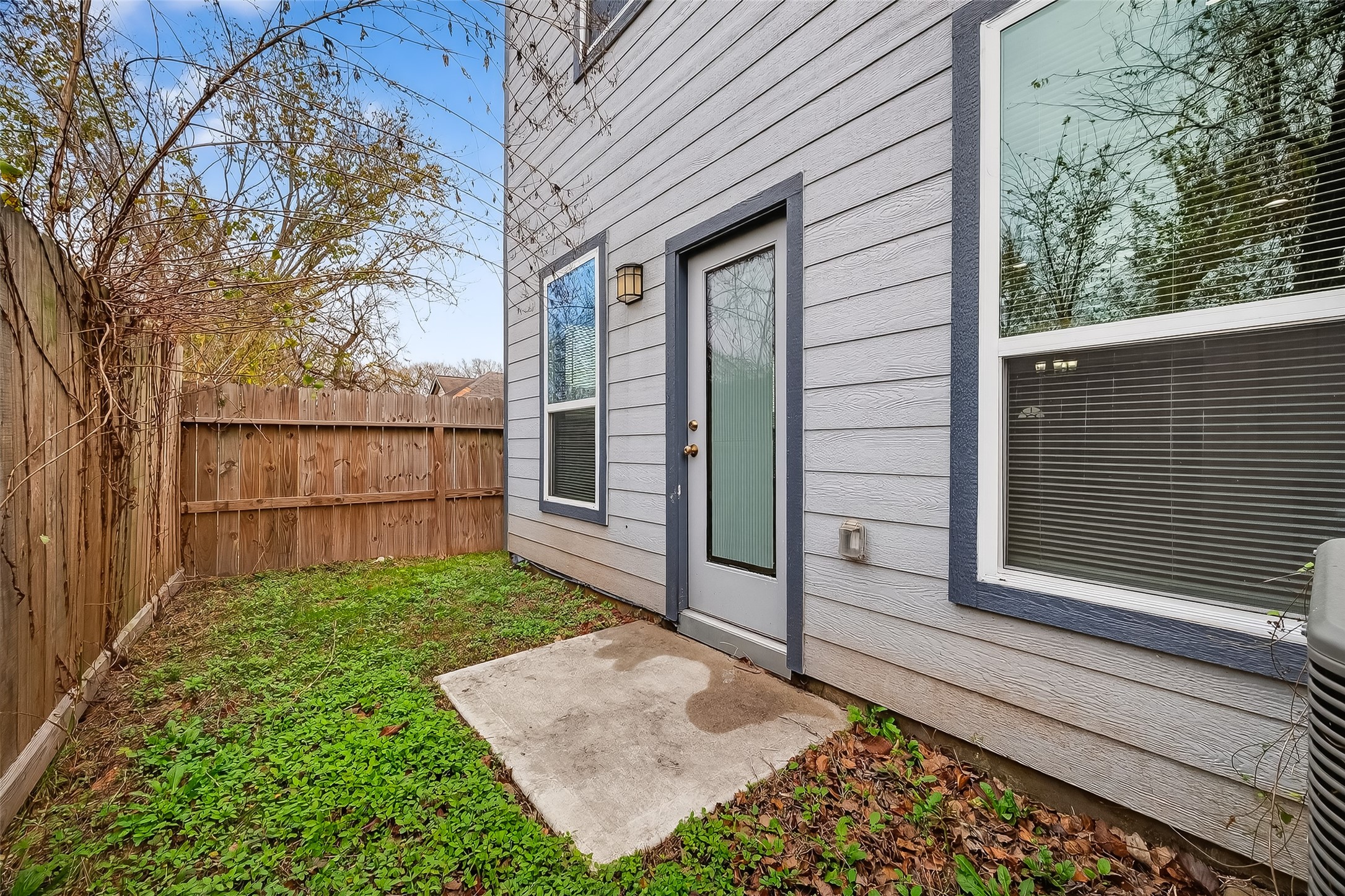 1411 Featherstone Street, Unit B Houston, TX 77020 - Photo 31 of 32 a view of a pathway of a house with a fence and a tree