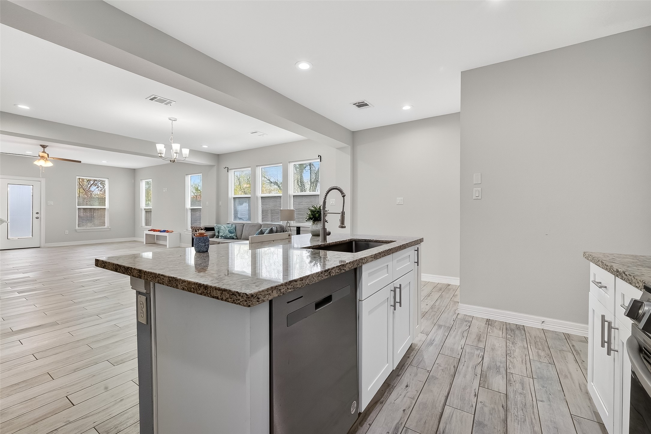 1411 Featherstone Street, Unit B Houston, TX 77020 - Photo 10 of 32 a kitchen with granite countertop a sink and wooden floor