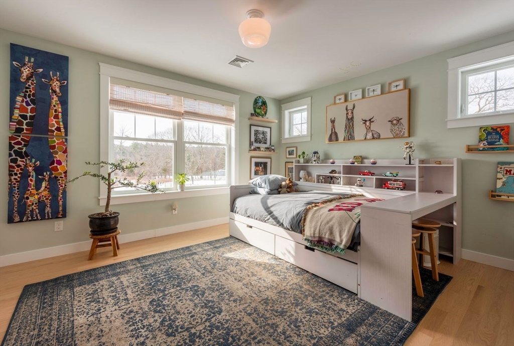5 John West Road Exeter, NH 03833 - Photo 19 of 33 a spacious bedroom with a bed and a window