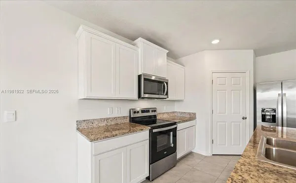 a kitchen with stainless steel appliances granite countertop a stove and a refrigerator