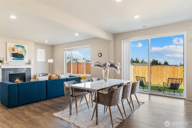 a view of a dining room with furniture large windows and wooden floor