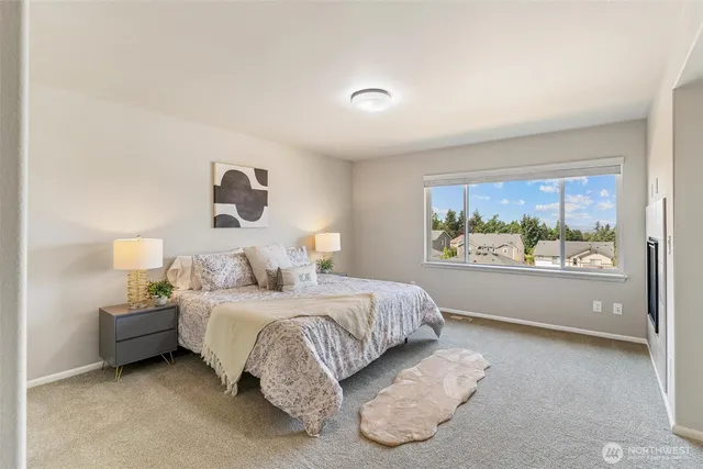 a spacious bedroom with a bed and a large window