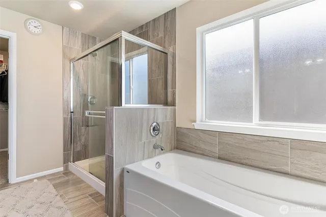 a bathroom with a bathtub and a shower