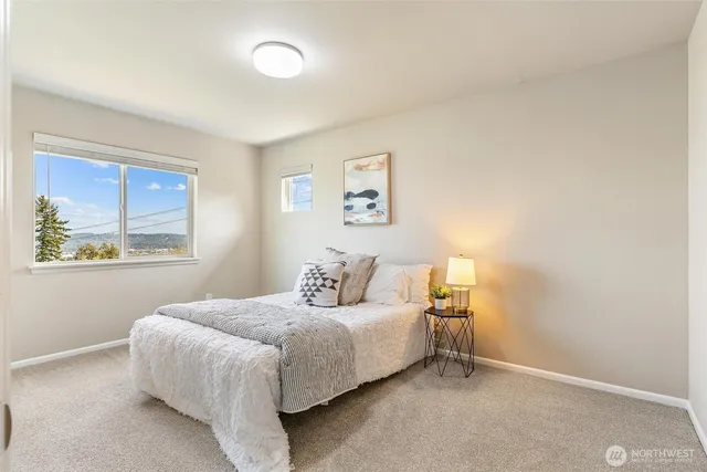 a bedroom with a bed and a window