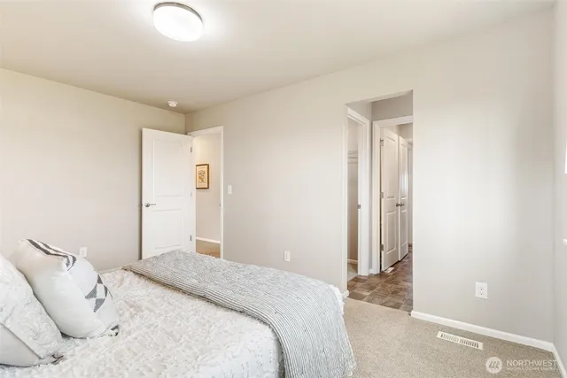 a bedroom with a bed and a mirror