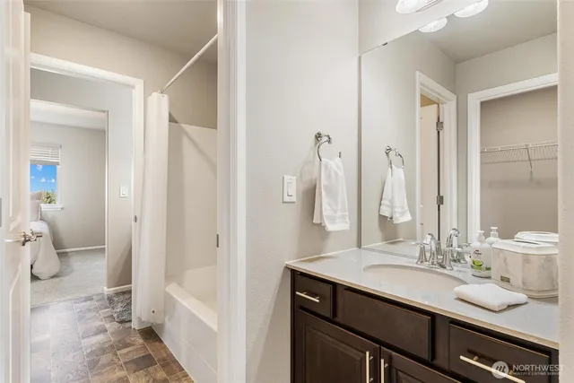 a bathroom with a double vanity sink a mirror and a shower
