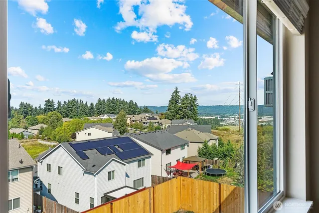 an aerial view of a house with a swimming pool a yard and outdoor seating