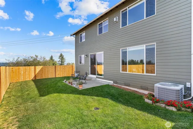 a view of backyard with swimming pool and outdoor seating