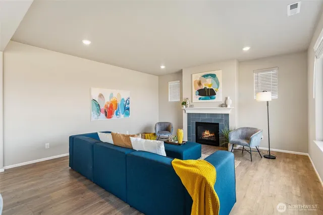 a living room with furniture a fireplace and a flat screen tv