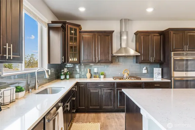 a kitchen that has a sink a stove and cabinets