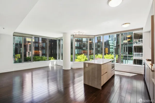 a room with wooden floors and large window