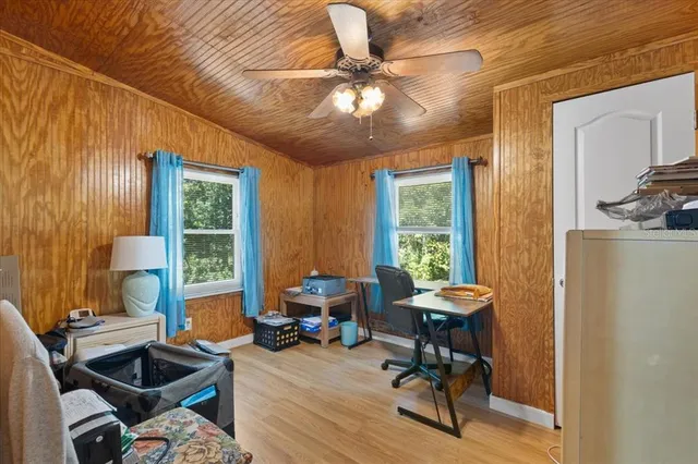 a view of a livingroom with workspace and a window
