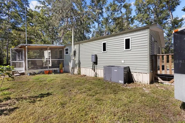 a view of a house with a backyard and porch