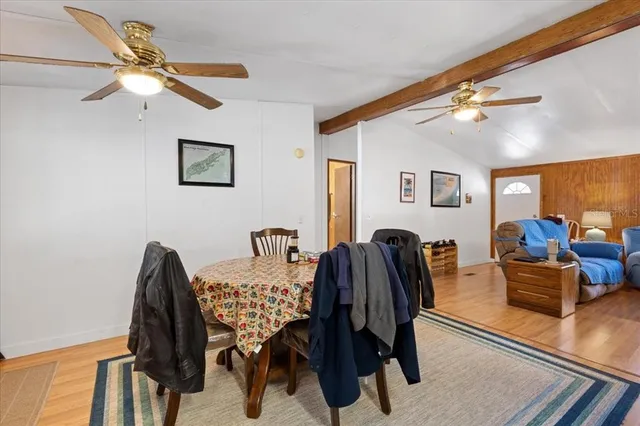 a view of a livingroom with furniture and a ceiling fan
