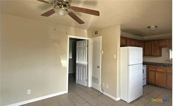 a refrigerator freezer sitting inside of a kitchen