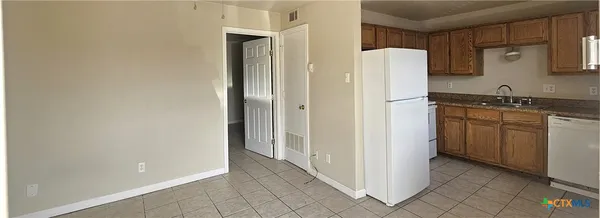 a white refrigerator freezer sitting inside of a kitchen