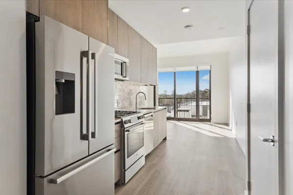 a kitchen with stainless steel appliances a refrigerator stove and sink