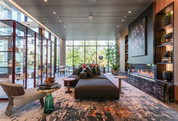 a view of living room with patio furniture and floor to ceiling windows