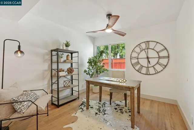 a backyard of a house with chairs and wooden fence