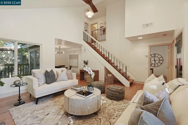 a living room with furniture and a potted plant