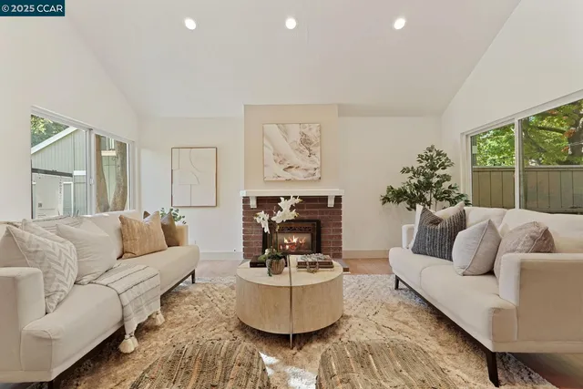 a living room with furniture and a fireplace