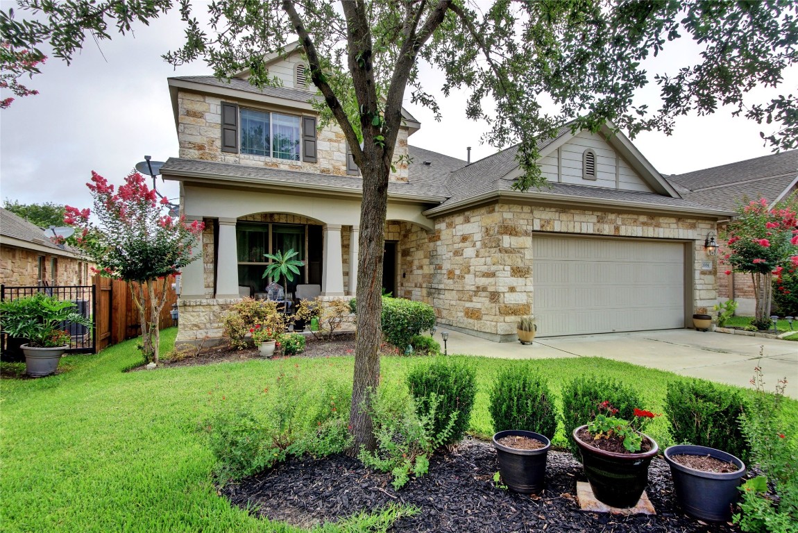 a front view of a house with a garden and plants