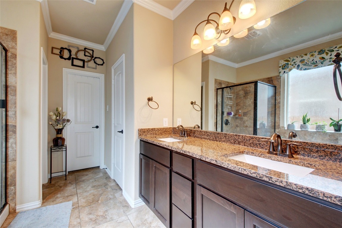 2004 Autumn Run Lane Round Rock, TX 78665 - Photo 16 of 35 a bathroom with a granite countertop sink a mirror and a shower