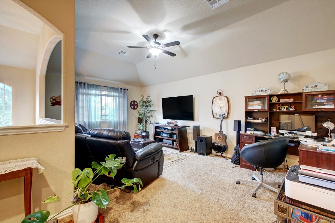 2004 Autumn Run Lane Round Rock, TX 78665 - Photo 17 of 35 a living room with furniture a chandelier and a flat screen tv