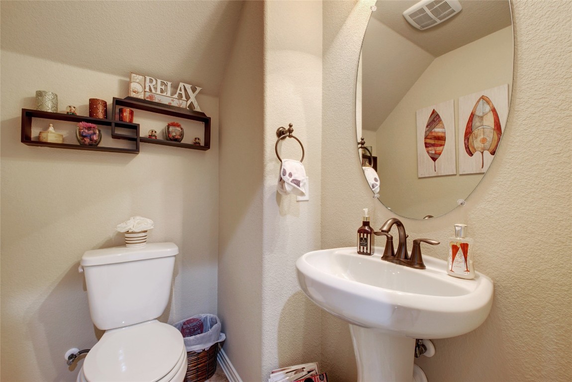 2004 Autumn Run Lane Round Rock, TX 78665 - Photo 22 of 35 a bathroom with a toilet sink and mirror