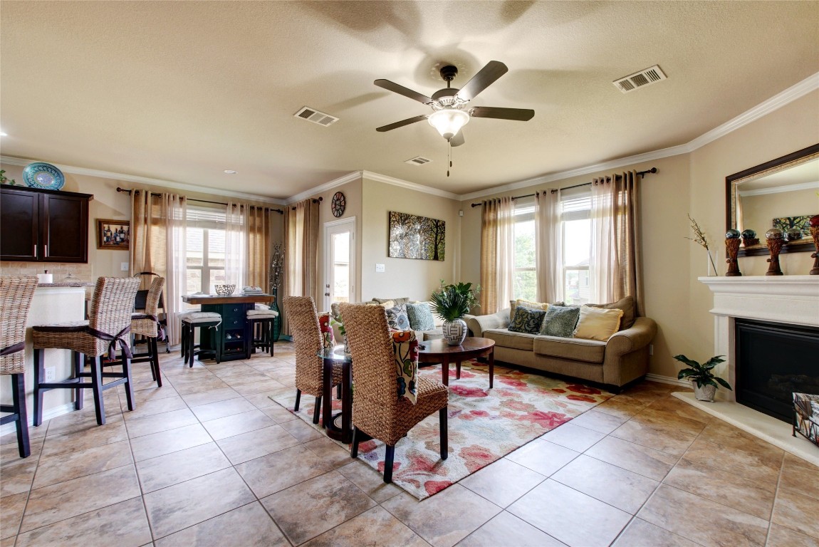 2004 Autumn Run Lane Round Rock, TX 78665 - Photo 5 of 35 a living room with furniture a fireplace and a flat screen tv